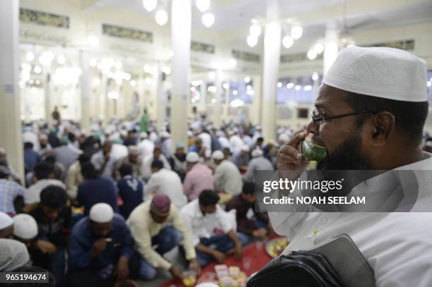 Indian Muslim devotees break their fast during the Holy month of Ramadan at the Jama Masjid in Secunderabad, the twin city of Hyderabad on June 1,...