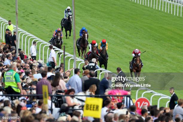 Frankie Dettori riding Cracksman wins the Investec Coronation Cup from Silvestre De Sousa riding Salouen during Ladies Day of the Investec Derby...