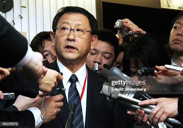 Akio Toyoda, president of Toyota Motor Corp., is surrounded by journalists after meeting with Seiji Maehara, Japan's minister for land and transport,...