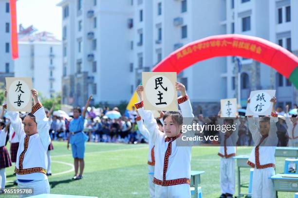 Primary students read poetry to celebrate the International Children's Day on June 1, 2018 in Xiangyang, Hubei Province of China.