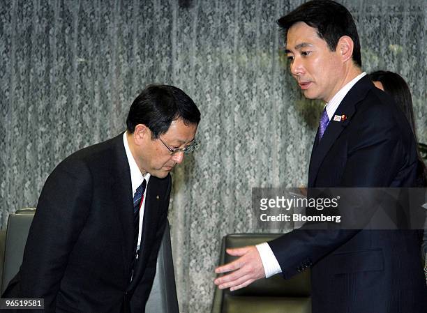 Akio Toyoda, president of Toyota Motor Corp., left, bows as he meets with Seiji Maehara, Japan's minister for land and transport, at the ministry in...