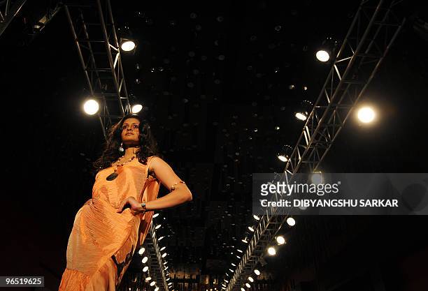 An Indian model walks the ramp as she presents a creation of designer Amita Sharma during the first day of the Bangalore Fashion Week in Bangalore on...