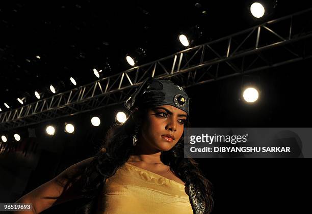 An Indian model walks the ramp as she presents a creation of designer Vipin Batra during the first day of the Bangalore Fashion Week in Bangalore on...