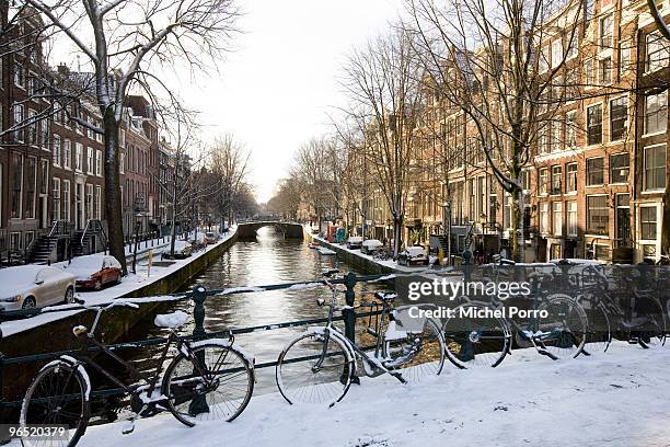 General view of bicycles on a bridge over a canal on January 30, 2010 in Amsterdam, Netherlands. Amsterdam with its many canals and bridges, often...