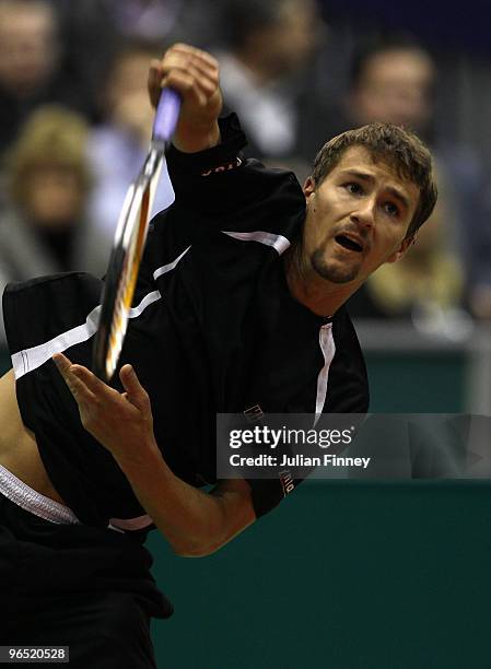 Marco Chiudinelli of Switzerland serves to Michael Llodra of France during day two of the ABN AMBRO World Tennis Tournament on February 9, 2010 in...