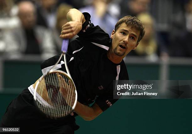 Marco Chiudinelli of Switzerland serves to Michael Llodra of France during day two of the ABN AMBRO World Tennis Tournament on February 9, 2010 in...