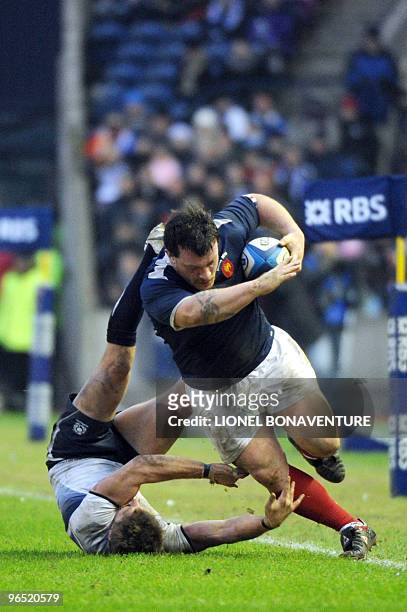 France's prop Thomas Domingo vies with Scotland scrum half and captain Chris Cusiter during their 6 nations' match Scotland vs France at the...