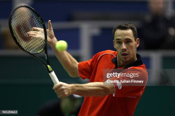 Michael Llodra of France plays a backhand in his match against Marco Chiudinelli of Switzerland during day two of the ABN AMBRO World Tennis...