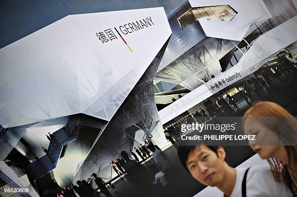 By D�Arcy Doran This picture taken on October 6, 2009 in Shanghai shows pedestrians walking past a billboard showing an artist's rendering of the...