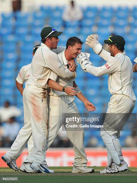 Dale Steyn of South Africa celebrates his 9th wicket as South Africa wins by an innings and 6 runs with teammates during day 4 of the 1st test...