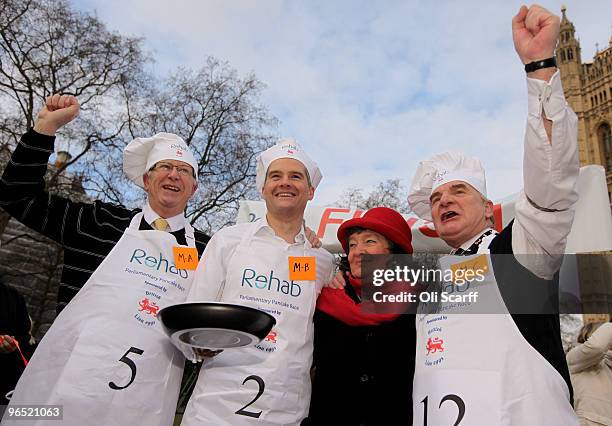 Victorious team of MPs celebrate after winning the annual Parliamentary Pancake Race in front of Houses of Parliament on February 9, 2010 in London,...