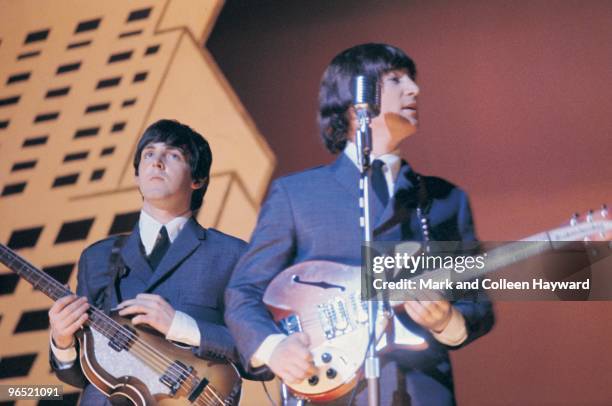 Paul McCartney and John Lennon performing with The Beatles during their American tour, August 1965.