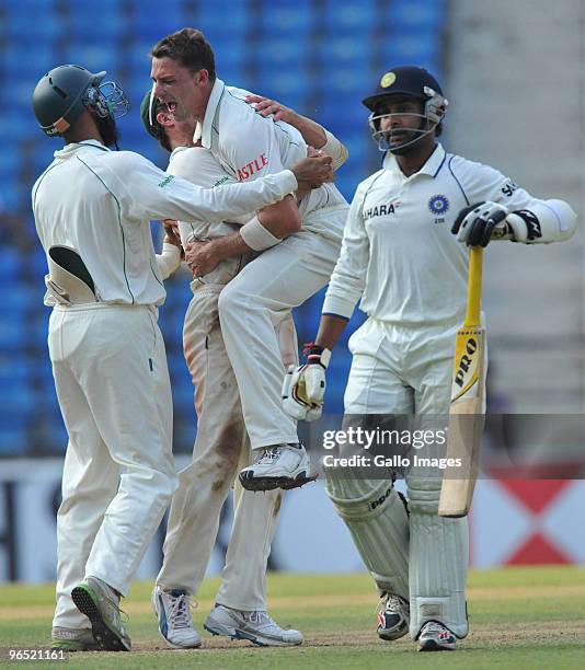 Dale Steyn of South Africa celebrates with teammates after taking his 10th wicket as South Africa wins by an innings and 6 runs during day 4 of the...