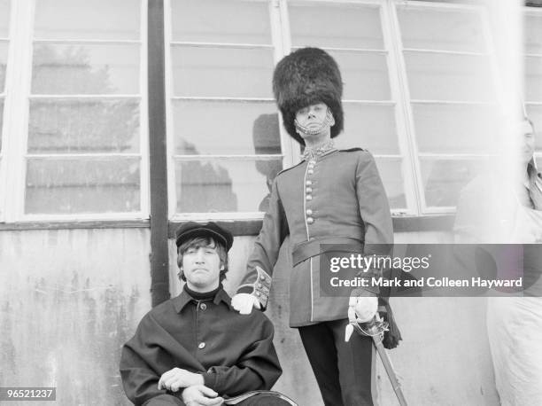 John Lennon of the Beatles with actor Victor Spinetti at Twickenham Studios, London, during a photo-shoot to complete the cover of the Beatles' album...