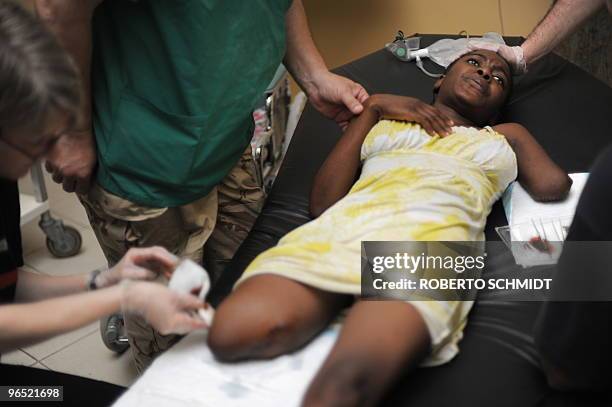 To go with scene story Haiti-quake-amputee by Lucile Malandain Darling Exinor has her wounds cleaned at a local hospital by international doctors in...