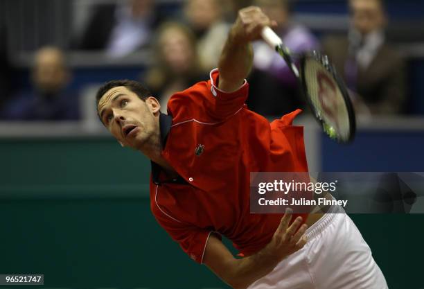 Michael Llodra of France serves to Marco Chiudinelli of Switzerland during day two of the ABN AMBRO World Tennis Tournament on February 9, 2010 in...