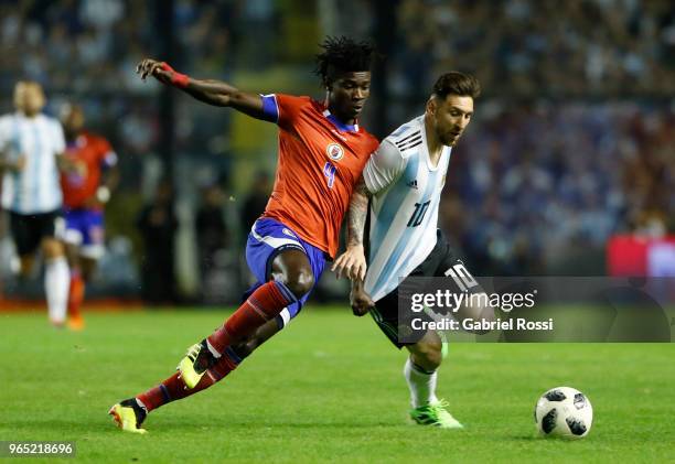 Lionel Messi of Argentina fights for the ball with Ricardo Ade of Haiti during an international friendly match between Argentina and Haiti at Alberto...