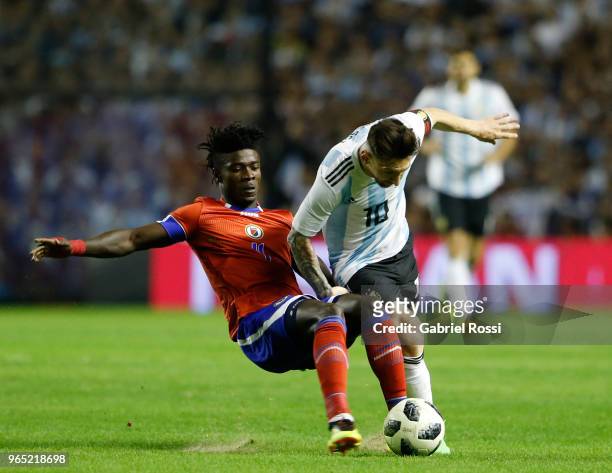 Lionel Messi of Argentina fights for the ball with Ricardo Ade of Haiti during an international friendly match between Argentina and Haiti at Alberto...