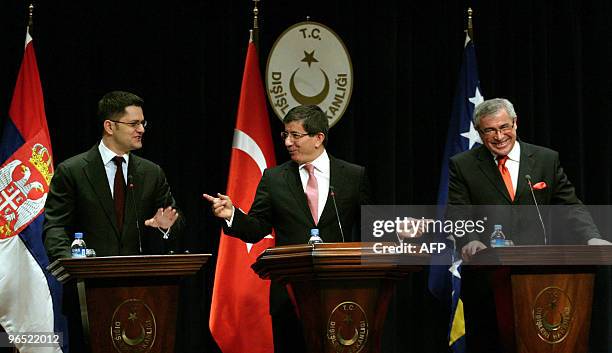 Foreign Ministers Vuk Jeremic of Serbia , Ahmet Davutoglu of Turkey and Sven Alkalaj of Bosnia speak as they stand on the podium during a meeting at...