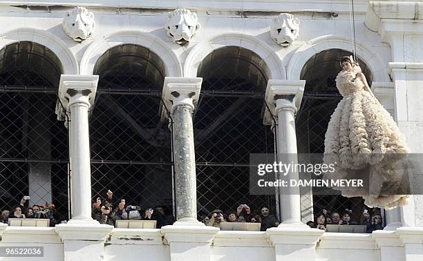 Spectators take pictures of Bianca Brandolini d'Adda as she performs the "Angel Flight" from the Campanile on San Marco square in Venice on February...