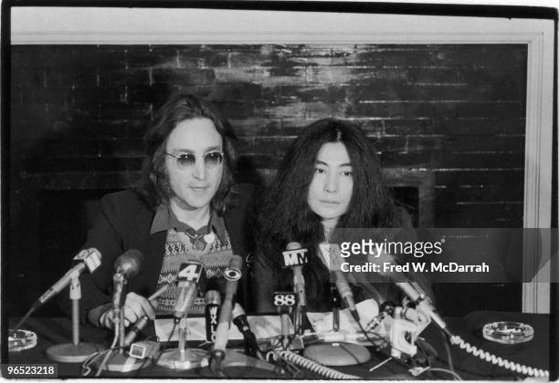 Close-up of British musician John Lennon and his wife Japanese-born American artist and musician Yoko Ono as they speak at a press conference where...