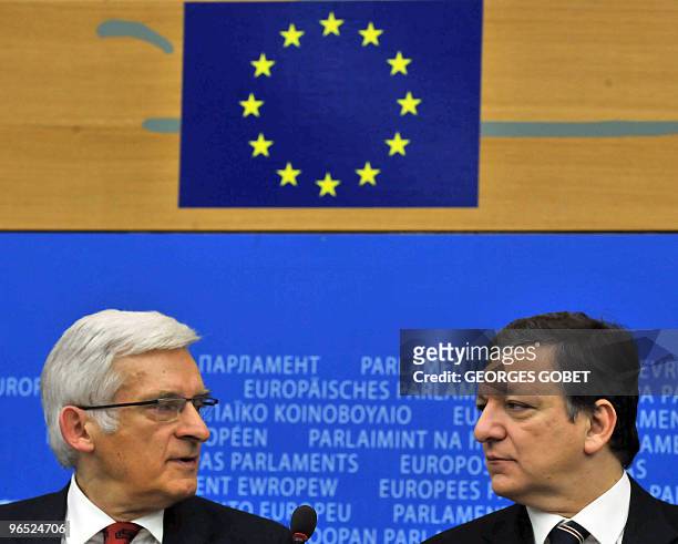European Parliament President Polish Jerzy Buzek and European Commission President Portuguese Jose Manuel Barroso look at each other as they give a...