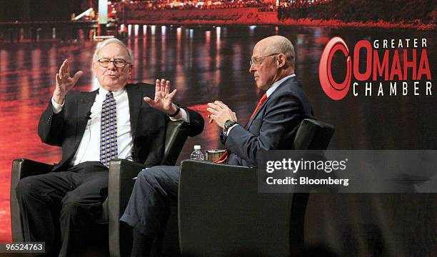 Warren Buffett, chairman and chief executive officer of Berkshire Hathaway Inc., left, speaks with Henry Paulson, former U.S. Treasury secretary,...