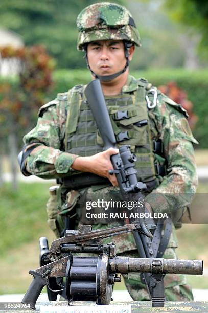 Colombian soldier stands next to a grenade launcher seized in Olaya municipality, West Antioquia department, Colombia on February 9, 2010. The...