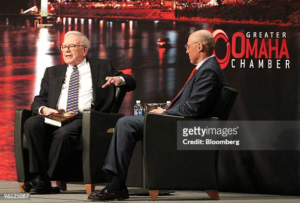 Warren Buffett, chairman and chief executive officer of Berkshire Hathaway Inc., left, speaks with Henry Paulson, former U.S. Treasury secretary,...