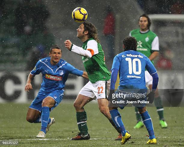 Torsten Frings of Bremen and Carlos Eduardo and Sejad Salihovic of Hoffenheim battle for the ball during the DFB Cup quarter final match between SV...