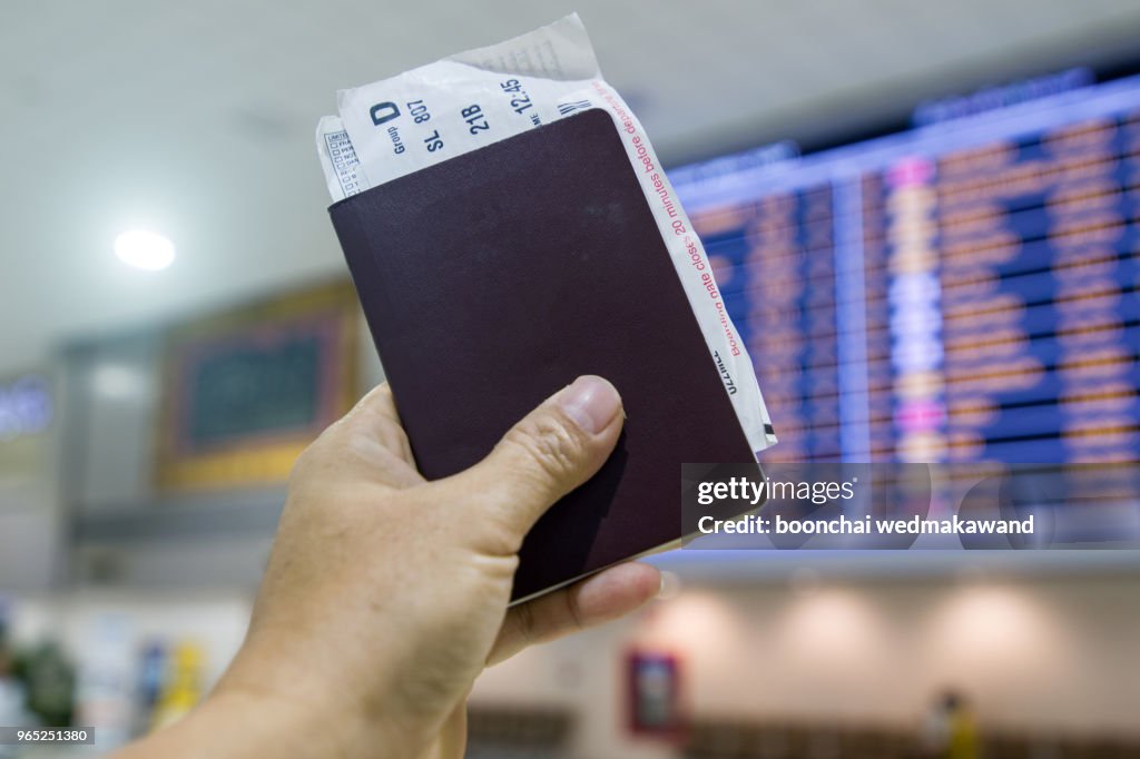 Passport and boarding pass looks at the airport departure