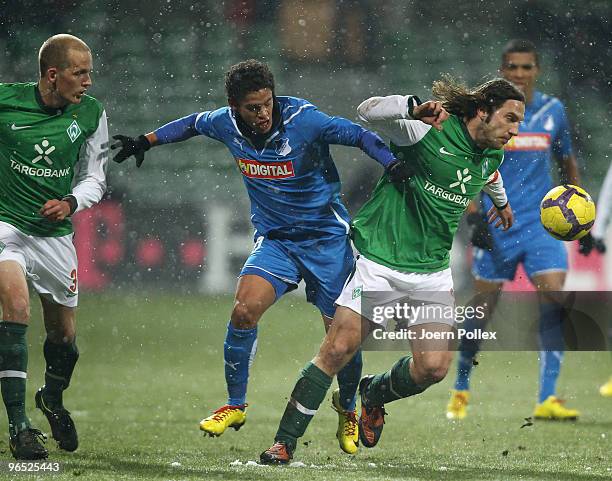 Torsten Frings of Bremen and Carlos Eduardo of Hoffenheim battle for the ball during the DFB Cup quarter final match between SV Werder Bremen and...