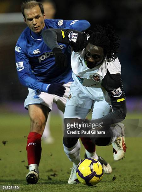 Angelo Basinas of Portsmouth battles for the ball with Kenwyne Jones of Sunderland during the Barclays Premier League match between Portsmouth and...