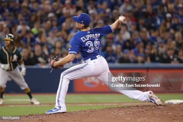 Tyler Clippard of the Toronto Blue Jays delivers a pitch in the eighth inning during MLB game action against the Oakland Athletics at Rogers Centre...