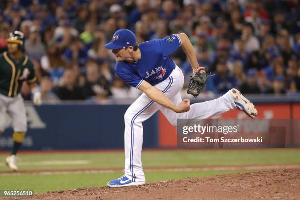 Tyler Clippard of the Toronto Blue Jays delivers a pitch in the eighth inning during MLB game action against the Oakland Athletics at Rogers Centre...