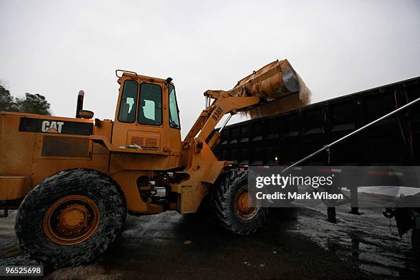 Loader operator Charles Thomas dumps road salt into a truck on February 9, 2010 in Benedict, Maryland. The Prince Frederick area, which is recovering...