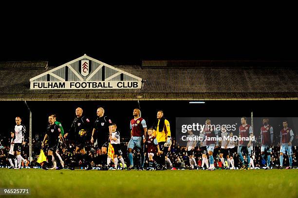 Fulham captian Danny Murphy, Burnley captain Clarke Carlisle and referee Steve Bennett lead the players onto the pitch prior to the Barclays Premier...