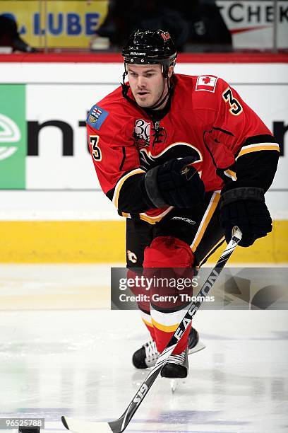 Ian White of the Calgary Flames skates with the puck against the Philadelphia Flyers on February 1, 2010 at Pengrowth Saddledome in Calgary, Alberta,...