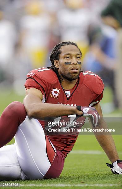 Larry Fitzgerald of the Arizona Cardinals stretches before a game against the Green Bay Packers in the NFC wild-card playoff game at University of...