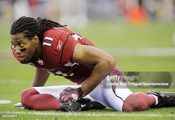 Larry Fitzgerald of the Arizona Cardinals stretches before a game against the Green Bay Packers in the NFC wild-card playoff game at University of...