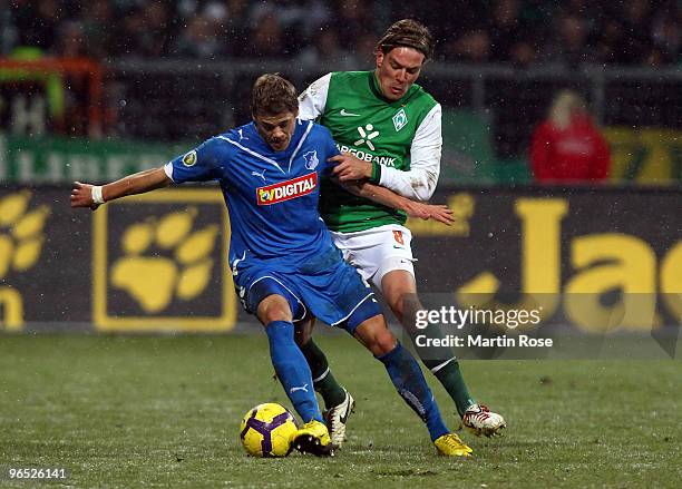 Clemens Fritz of Bremen and Boris Vukcevic of Hoffenheim battle for the ball during the DFB Cup quarter final match between SV Werder Bremen and 1899...