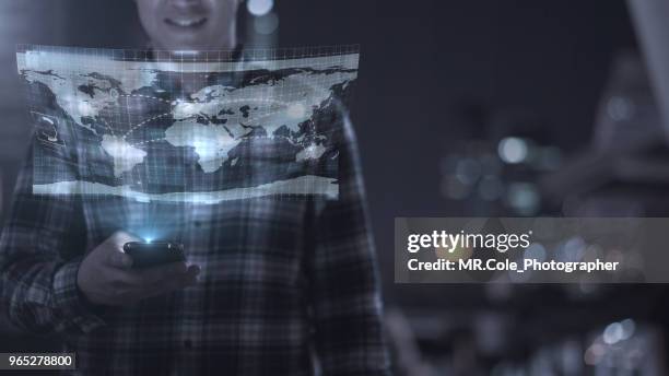 business man on casual ware look to the hologram technology of world connection - holographic-map fotografías e imágenes de stock