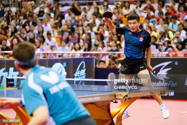 Liang Jingkun of China competes in the Men's Singles eighth-final match against Timo Boll of German during day two of the 2018 ITTF World Tour China...