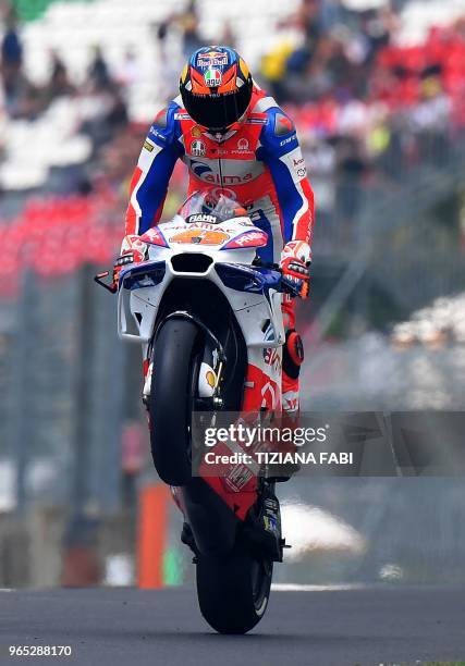 Marc VDS' Australian rider Jack Miller perfoms a wheeling during a free practice session ahead of the Italian MotoGP Grand Prix at the Mugello...