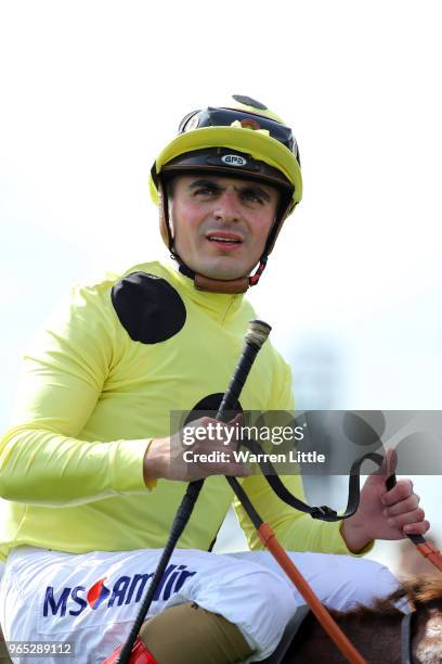 Andrea Atzeni riding Ajman King celebrates winning the Investec Wealth & Investment Handicap during Ladies Day of the Investec Derby Festival at...