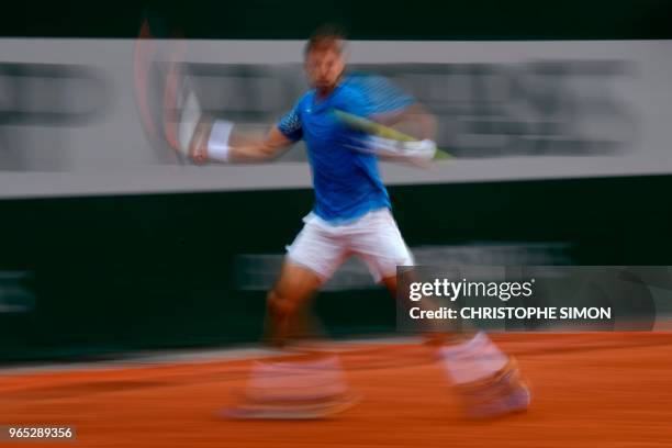 In this photograph taken with a slow shutter speed, Spain's Pablo Carreno Busta prepares to play a forehand return to Italy's Marco Cecchinato during...