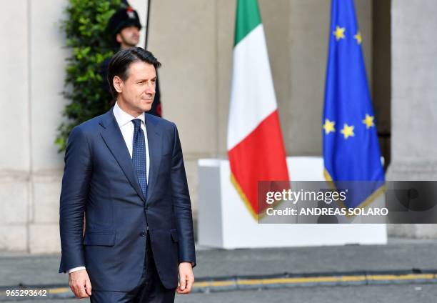 Newly appointed Italy's Prime Minister Giuseppe Conte reviews a guard of honor upon his arrival at Chigi palace for the bell ceremony, signifying the...