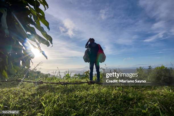 man standing in top of the mountain - tagaytay stock pictures, royalty-free photos & images