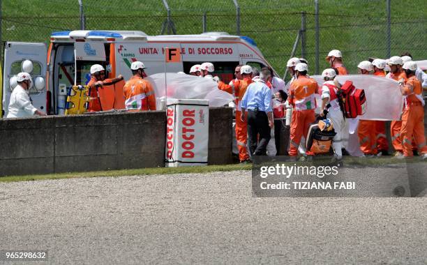 Ducati Team's italian rider Michele Pirro is stretched out after a crash during a free practice session ahead of the Italian MotoGP Grand Prix at the...