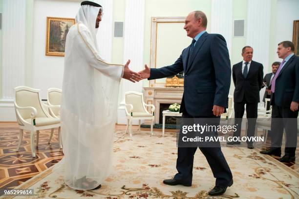 Russian President Vladimir Putin shakes hands with Abu Dhabi Crown Prince Mohammed bin Zayed al-Nahayan during their meeting at the Kremlin in Moscow...